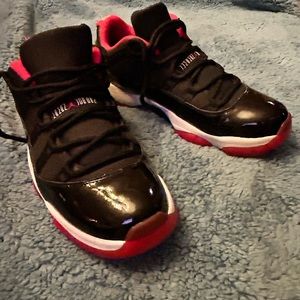 Air Jordan basketball shoe. Low. Black patent  with red and white trim.